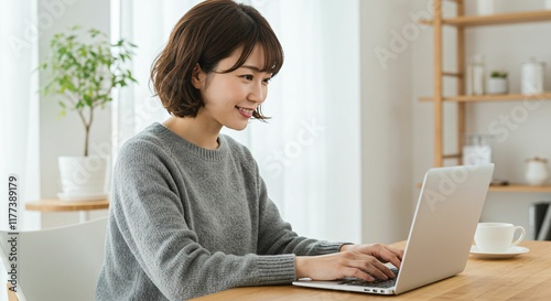 Focused Japanese Woman with Medium Brown Hair Working Remotely from a Bright Home Office with a Minimalist Interior