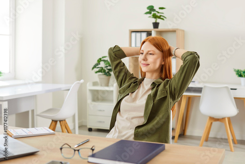 Portrait of a happy Caucasian woman resting and relaxing during online work at home, leaning back in a chair. Calm and tranquility, enjoyable moment as she manages remote work in home office.