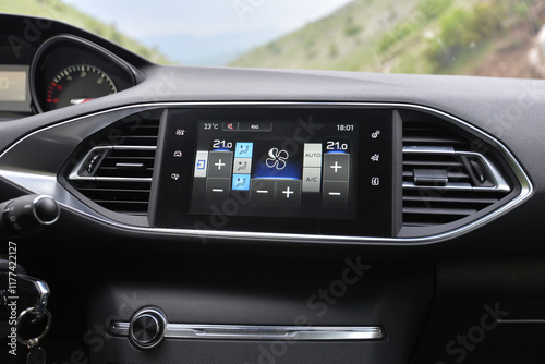 Modern car interior detail: climate control and infotainment screen