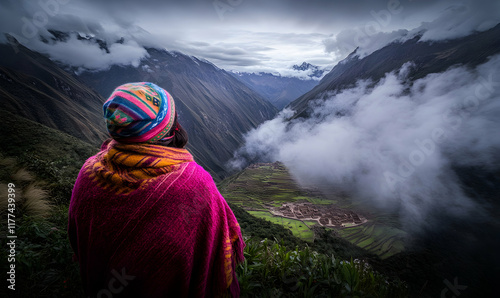 Woman in vibrant Andean attire gazes at breathtaking misty mountain valley and ancient terraces.  A stunning vista of Peru's natural beauty. photo