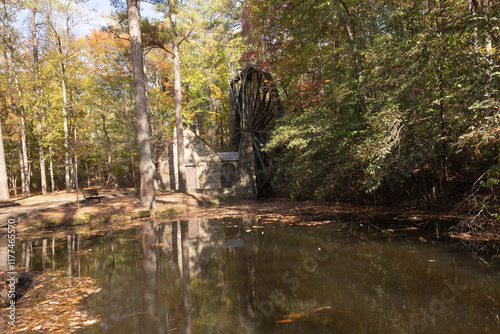 Old grist mill with a water wheel photo