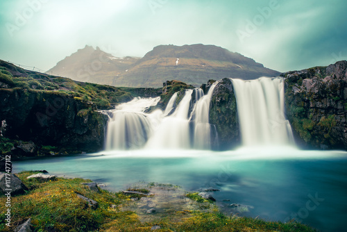 Fototapeta Naklejka Na Ścianę i Meble -  View to the Kirkjufell waterfall at summer. Kirkjufellsfoss waterfall, Iceland, Europe.