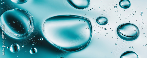 Large and small water drops creating an abstract pattern on a teal background
