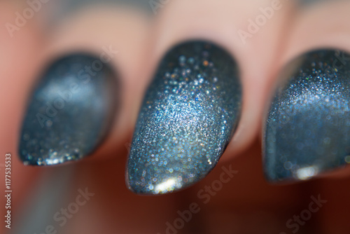 Magnetic nails with a cat eye effect reveal a macro manicure transitioning from vivid blue to shimmering silver, creating a captivating balance of boldness and sophistication. photo