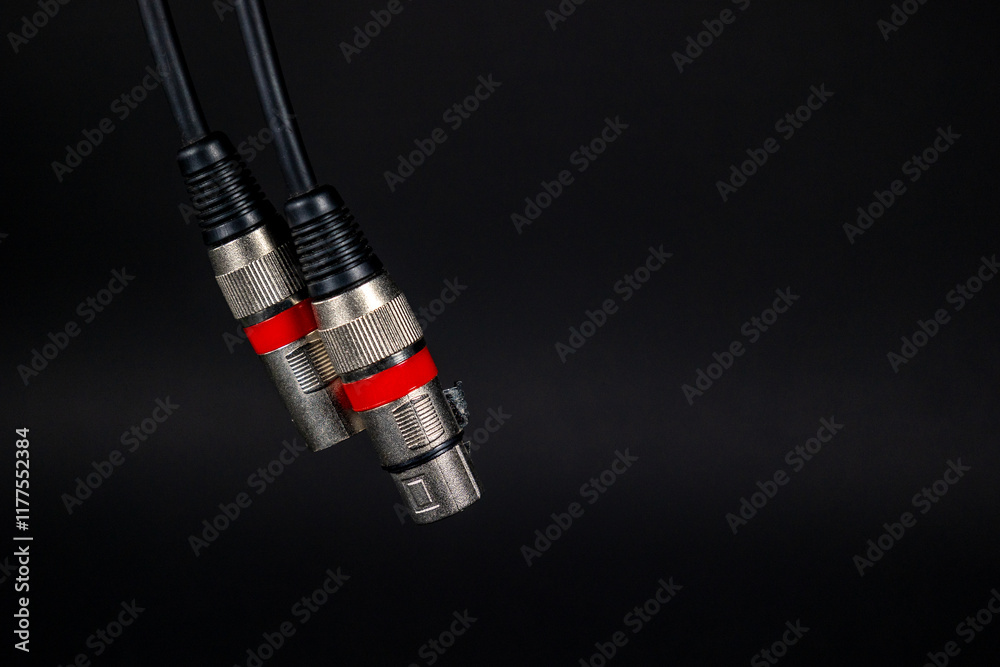 Audio instrument xlr cable hanging on a black background. Concept: Audio, professional audio.