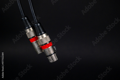 Obraz na płótnie Audio instrument xlr cable hanging on a black background. Concept: Audio, professional audio. w salonie