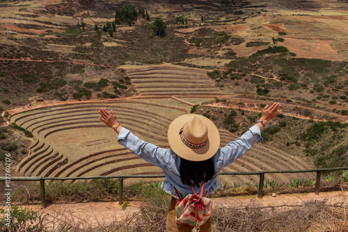 Young Latin tourist visiting Moray; the Inca agricultural laboratory in dry season photo