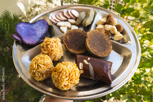 A Plate of jaggery, sesame balls, yam, sweet potato for Maghe Sankranti Festival or Pre Workout Meal photo