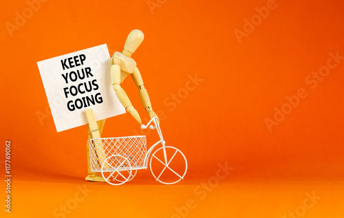 Keep your focus going symbol. Concept words Keep your focus going on beautiful white paper. Beautiful orange background. Miniature bicycle. Business and keep your focus going concept. Copy space. photo