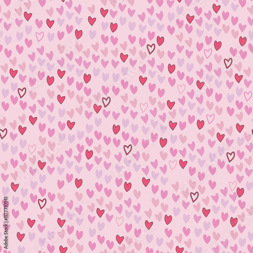A seamless vector, blending pattern of pink and red hearts irregularly scattered on a light pink background. Great for digital Valentines projects backgrounds, fabrics, or gift wraps.