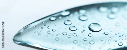 Water droplets creating a stunning textured surface on light blue background