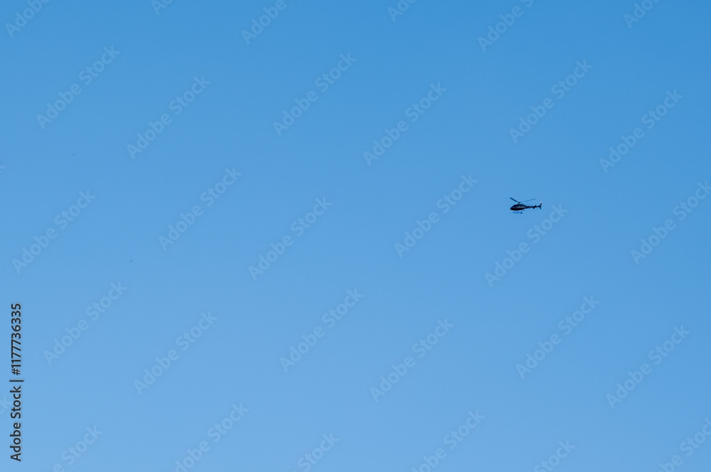 Small helicopter on a blue sky background. Small helicopter on a blue sky background.