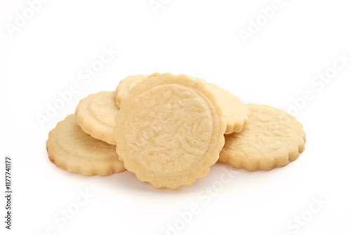 Pile of butter cookies. Multiple round French cookies also known as  Parisian butter cookies, soleils or sablés. Tea biscuit or for holiday gifting. Selective focus. White background. photo