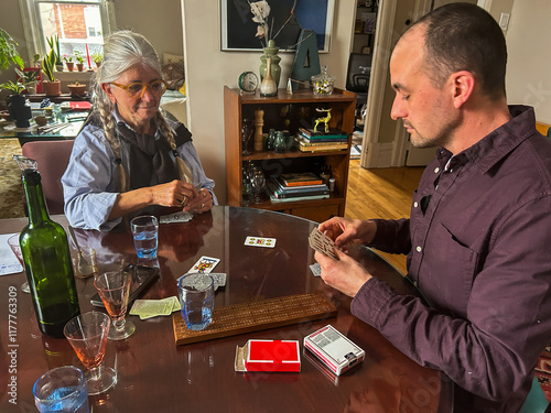 UGC Mother and Son playing card at home  photo