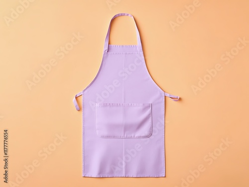 Soft pastel purple apron isolated on a pale orange solid background for unique visuals photo