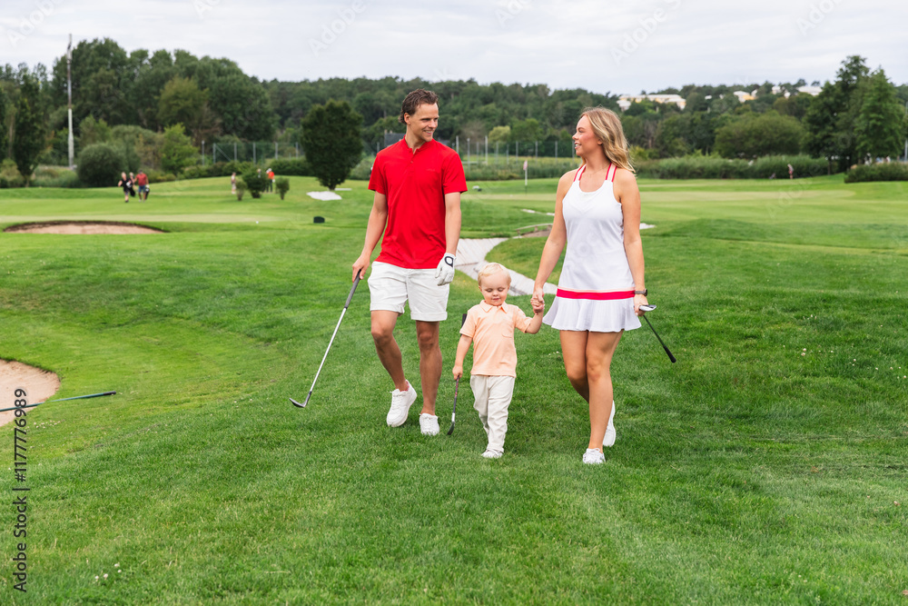 Family Walking with Young Son in Golf Field Family Walking with Young Son in Golf Field