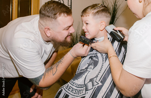 A dad and his son get pampered at the barbershop. photo