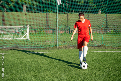 Female soccer player training with the ball photo