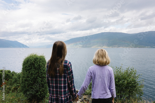 Kids looking at the fjord in Norway photo