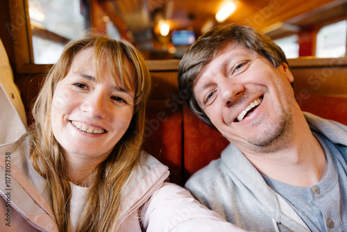 A couple took a selfie photo in a train