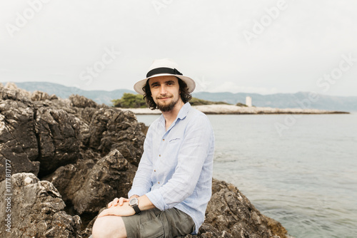 man sitting on a stone photo