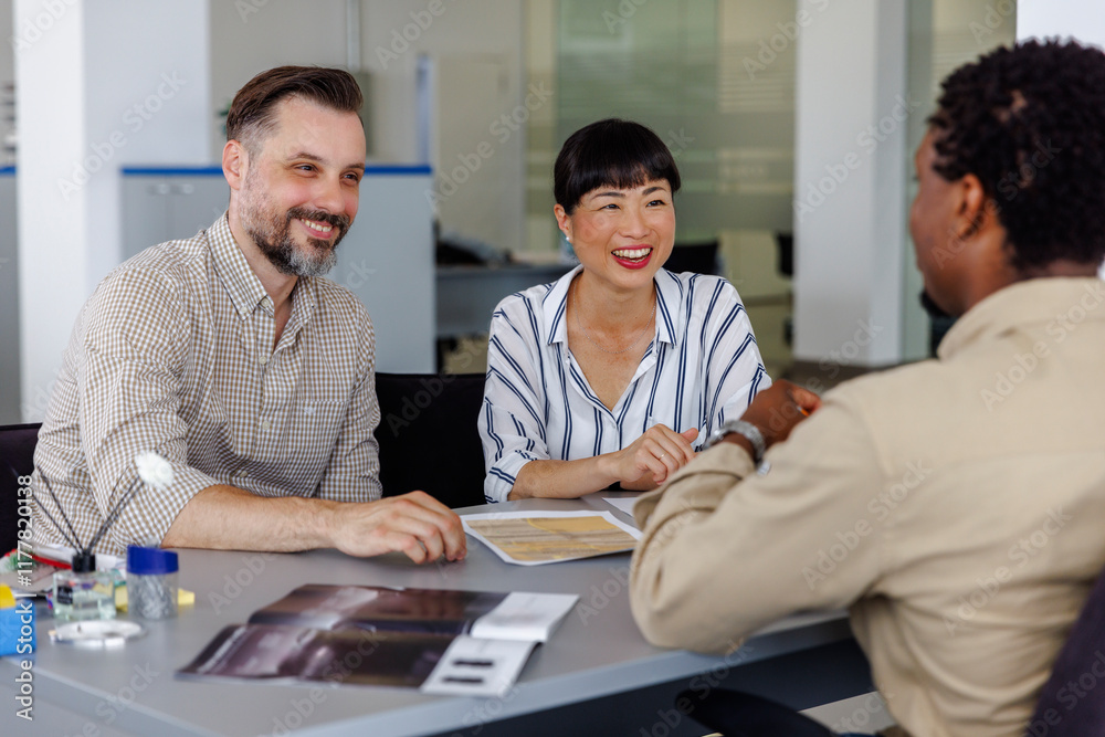 Happy colleagues discussing in meeting at office Happy colleagues discussing in meeting at office