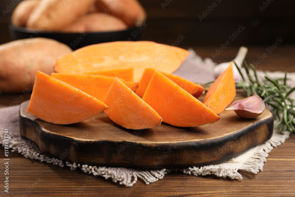 Sliced sweet potato on wooden table, closeup Sliced sweet potato on wooden table, closeup