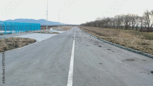 moving forward on a muddy asphalt empty road in the plain