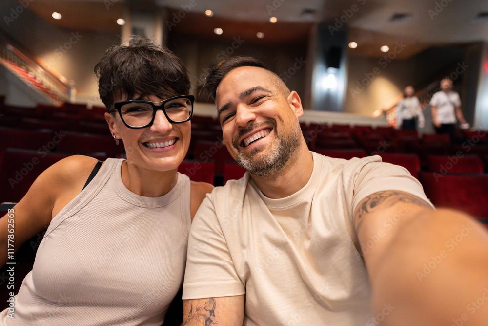 Happy couple taking a selfie in theater in manhattan, new york city