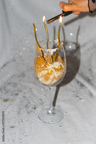 Dessert celebration with lit candles on a glass of whipped cream  photo