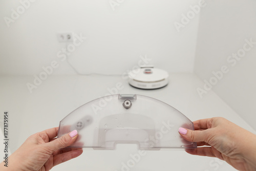 Water container closeup in female hand for wet cleaning photo