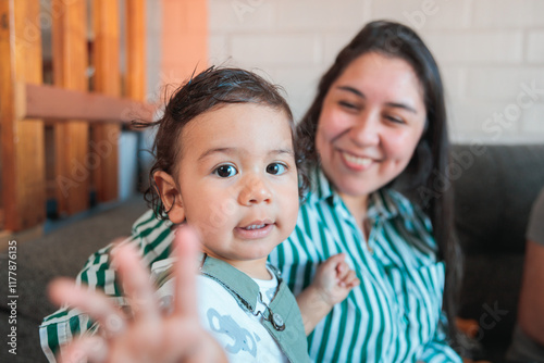 Latin Mother Holding Her Child at Home photo