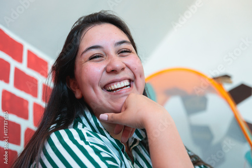 Close-Up Portrait of a Cheerful Young Latin Woman photo