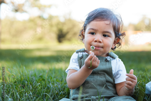 Cute Little Child Playing with a Flower photo