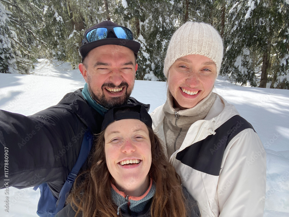 Selfie of laughing friends in the snowy forest Selfie of laughing friends in the snowy forest
