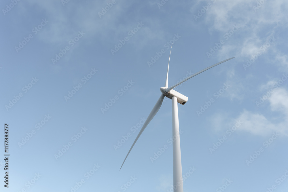 Wind turbine generating clean energy under blue sky Wind turbine generating clean energy under blue sky