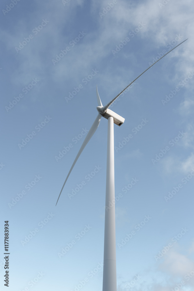 Wind turbine generating clean energy under blue sky Wind turbine generating clean energy under blue sky