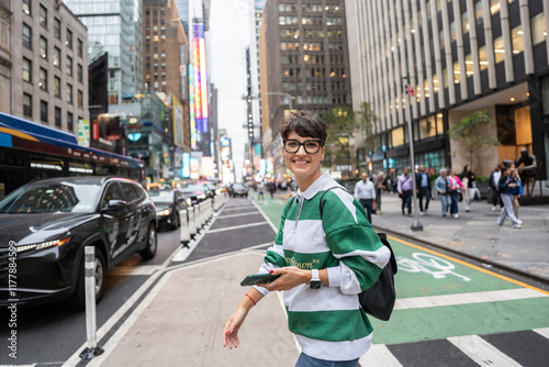 Young woman walking in times square, manhattan, new york city photo