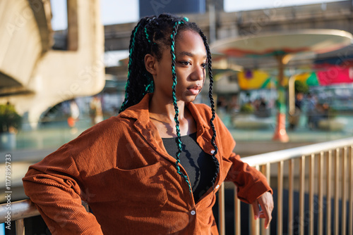 Thoughtful hipster woman looking up at gaming zone