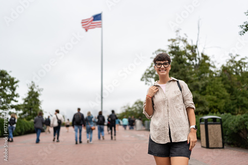 Tourist smiling with american flag waving in new york city
