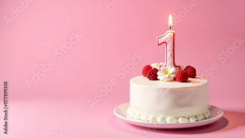 A white frosted birthday cake features a bright red number one candle on top. Fresh raspberries and decorative flowers surround the candle, set against a soft pink backdrop for a festive celebration. photo