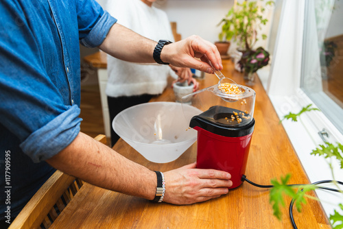 Unrecognizable man Making Popcorn at Home for Movie Night photo