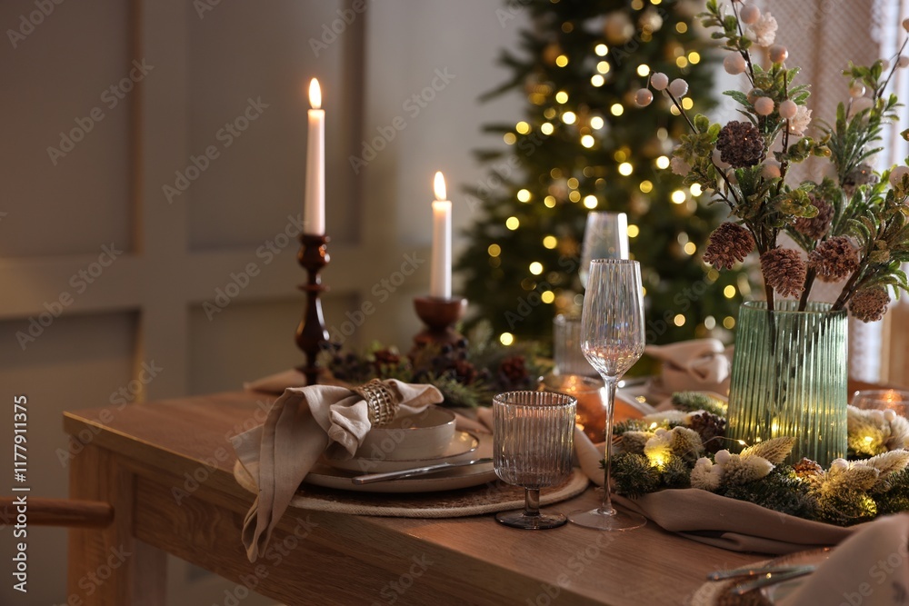 Christmas table setting with stylish dishware, glasses and burning candles in festive decorated room Christmas table setting with stylish dishware, glasses and burning candles in festive decorated room