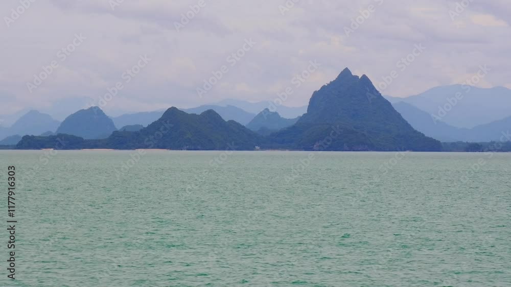 Serene Mountain Peaks Emerging from the Mist: A breathtaking vista of rugged mountain peaks rising majestically from a tranquil sea, shrouded in a veil of mist. The calm. Serene Mountain Peaks Emerging from the Mist: A breathtaking vista of rugged mountain peaks rising majestically from a tranquil sea, shrouded in a veil of mist. The calm.
