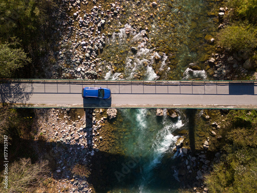 Car in the bridge over mountain river Tara photo