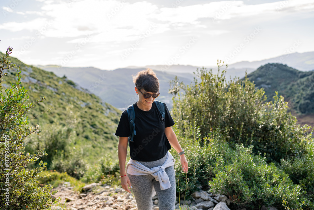 Tourist hiking on mountain trail enjoying scenic nature Tourist hiking on mountain trail enjoying scenic nature