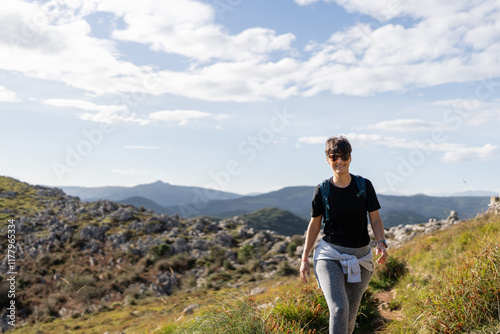 Hiker walking on a mountain path enjoying the scenic view photo