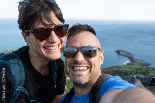 Hikers taking a selfie while hiking in the mountains near the sea photo