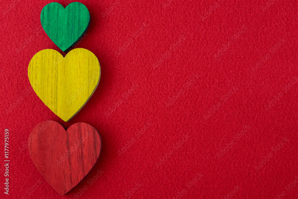 Obraz premium Traffic light green, yellow, red hearts on the red background.