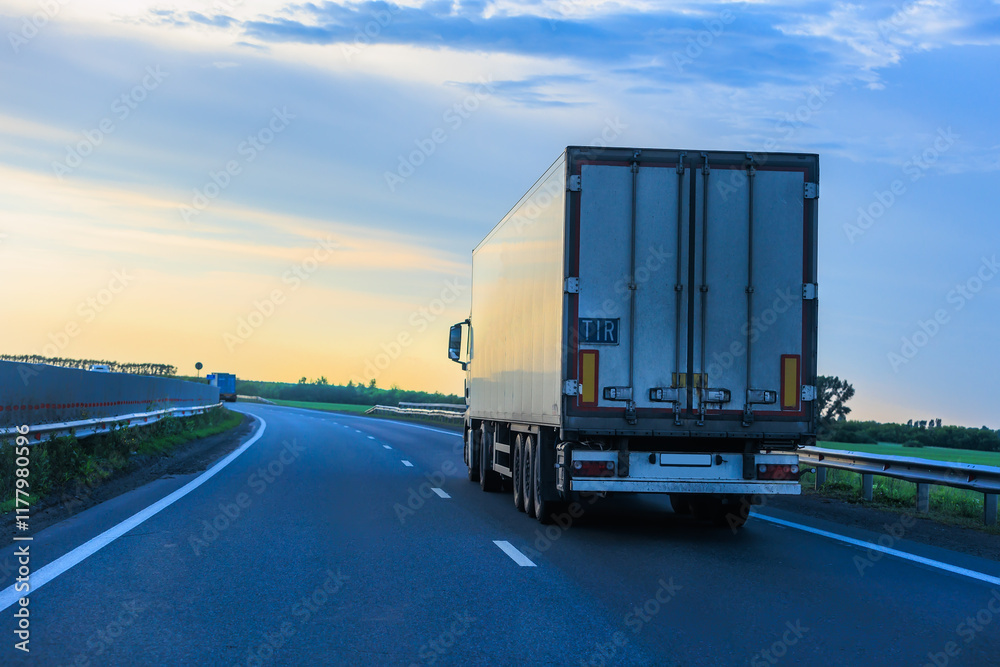 truck moves around a bend in a country truck moves around a bend in a country